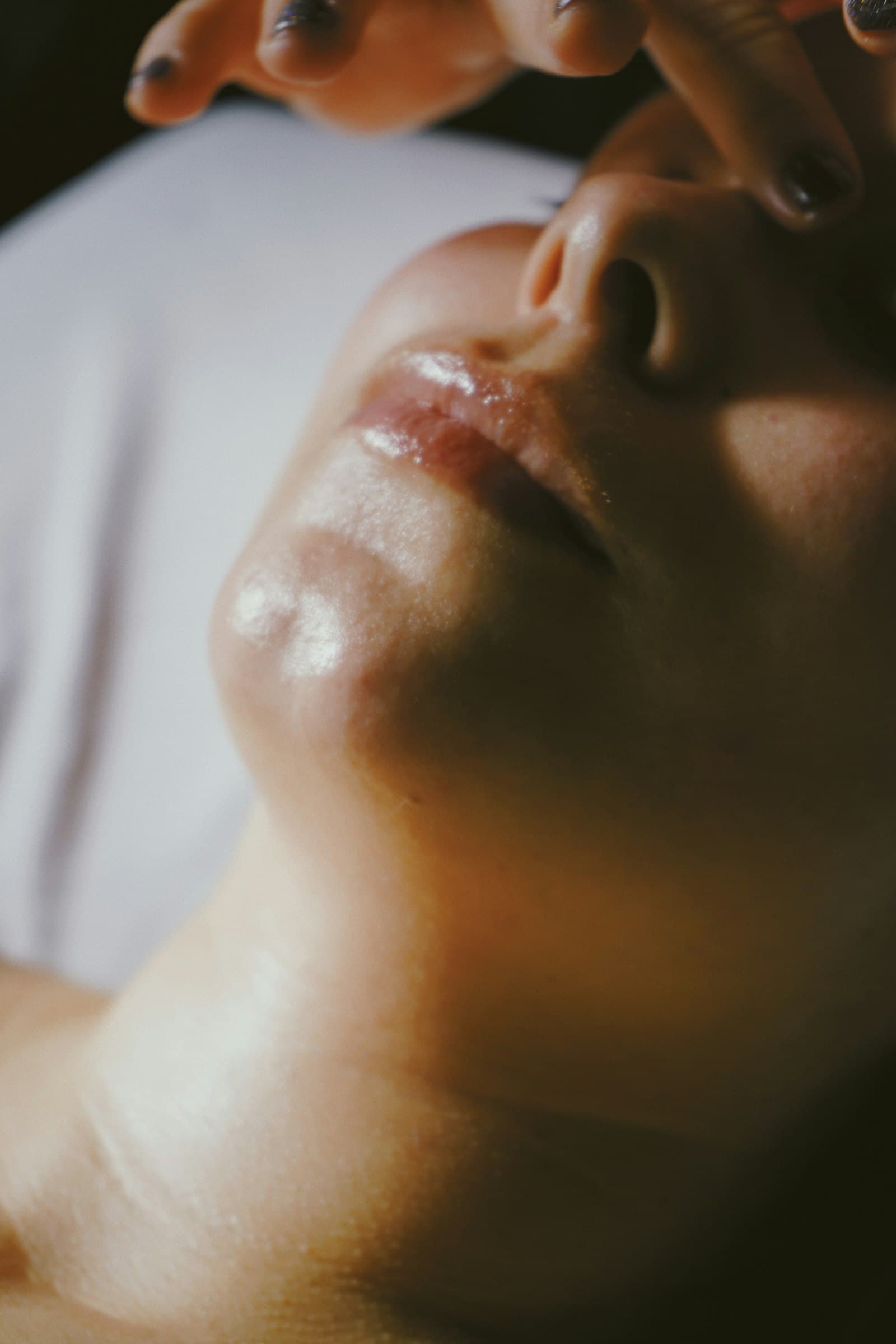 Client relaxing during a facial massage treatment