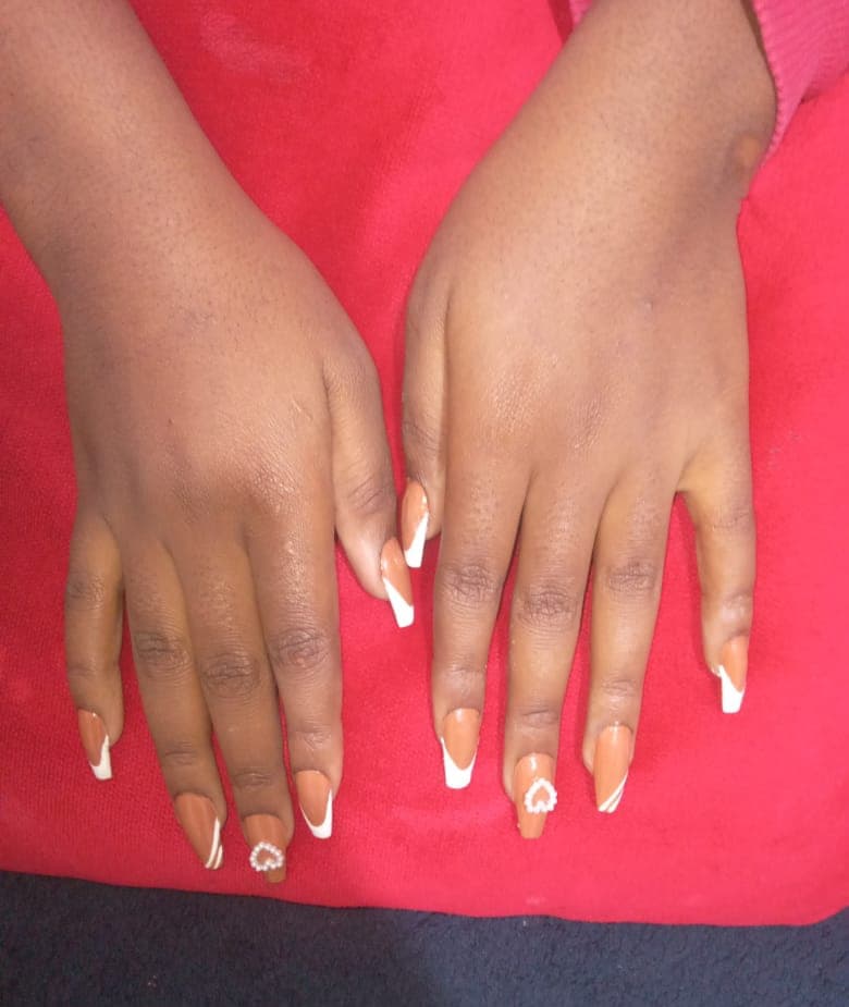Client showing off a fresh nail set from Saylor Beauty Spa